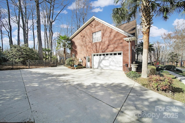 907 Thorn Ridge Ln, Lake Wylie, SC 29710 - view of side of home featuring driveway, brick siding, and an attached garage