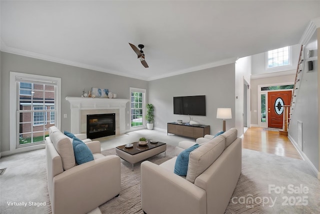 907 Thorn Ridge Ln, Lake Wylie, SC 29710 - living room featuring ceiling fan, crown molding, baseboards, light carpet, and a fireplace with flush hearth