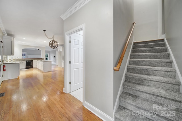 907 Thorn Ridge Ln, Lake Wylie, SC 29710 - stairs with wood finished floors, ornamental molding, arched walkways, baseboards, and a chandelier