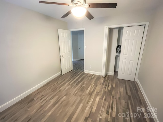 unfurnished bedroom with dark hardwood / wood-style floors, ceiling fan, and a closet