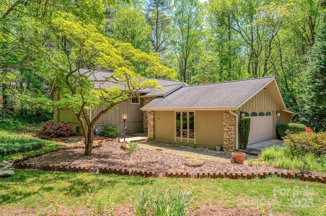 view of front of house featuring a shingled roof, board and batten siding, and stone siding