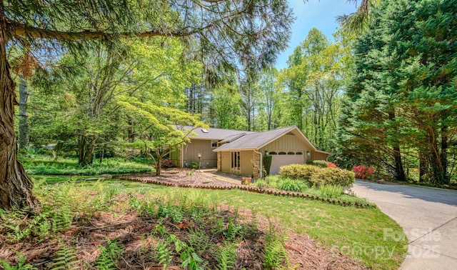 ranch-style home with a garage and driveway