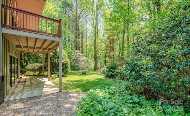 view of yard featuring a patio area and a wooden deck