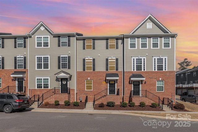 multi unit property featuring brick siding