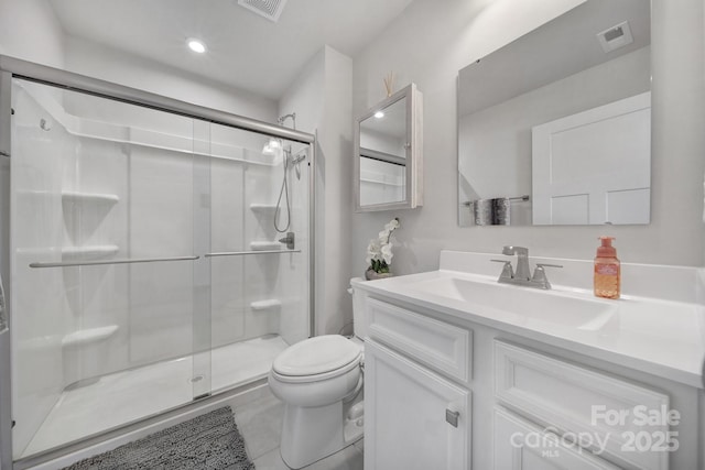 bathroom with vanity, toilet, and an enclosed shower