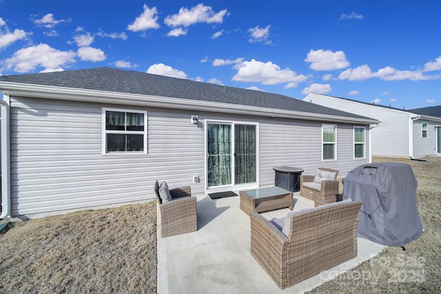 back of property with an outdoor living space and a patio area