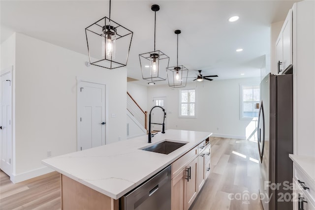 kitchen featuring light wood finished floors, stainless steel appliances, recessed lighting, a kitchen island with sink, and a sink