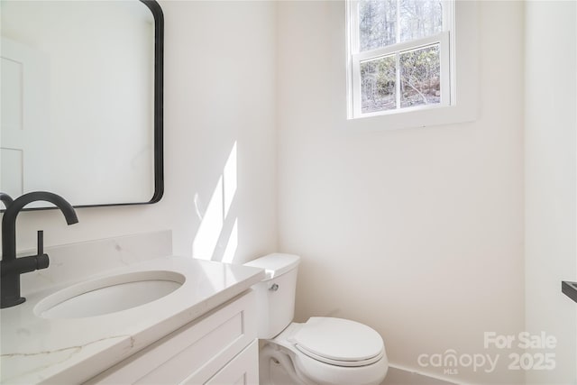 bathroom featuring vanity and toilet