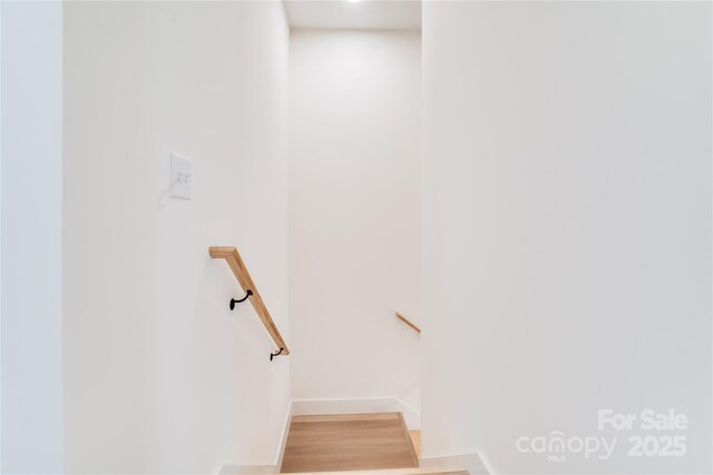 staircase featuring wood finished floors