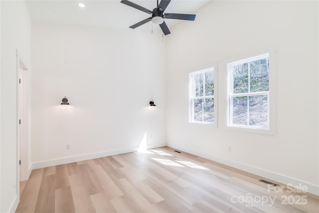 unfurnished room featuring ceiling fan, recessed lighting, visible vents, baseboards, and light wood-style floors