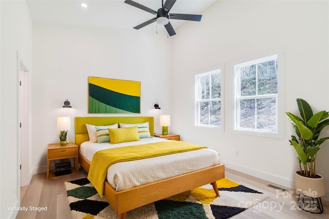 bedroom with recessed lighting, wood finished floors, visible vents, and baseboards