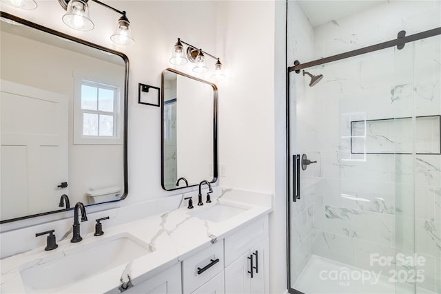 bathroom featuring double vanity, a shower stall, and a sink