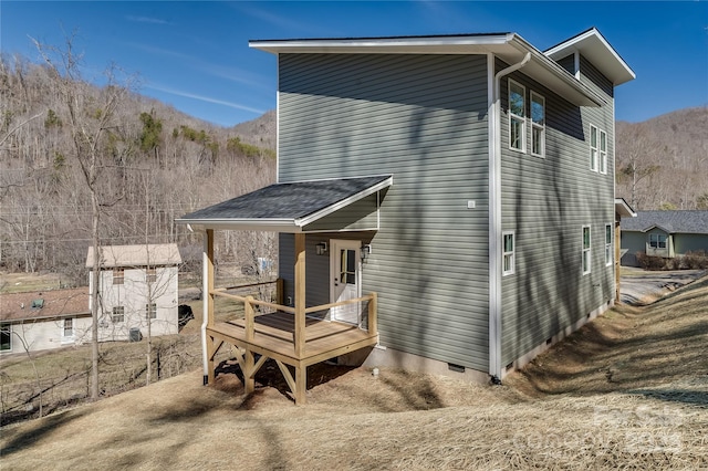 rear view of property with crawl space