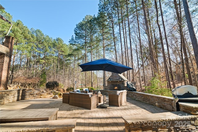 view of patio / terrace featuring an outdoor living space with a fireplace