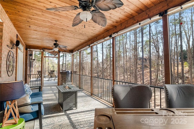 unfurnished sunroom with ceiling fan and wood ceiling