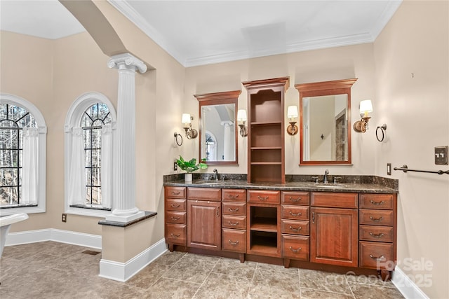 bathroom with ornate columns, vanity, and crown molding