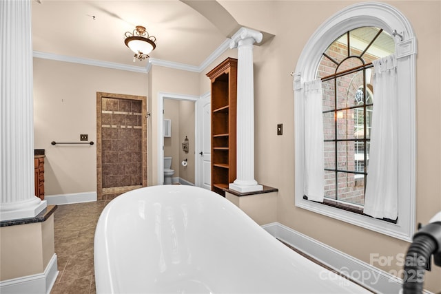 bathroom featuring vanity, ornamental molding, a tub, toilet, and ornate columns