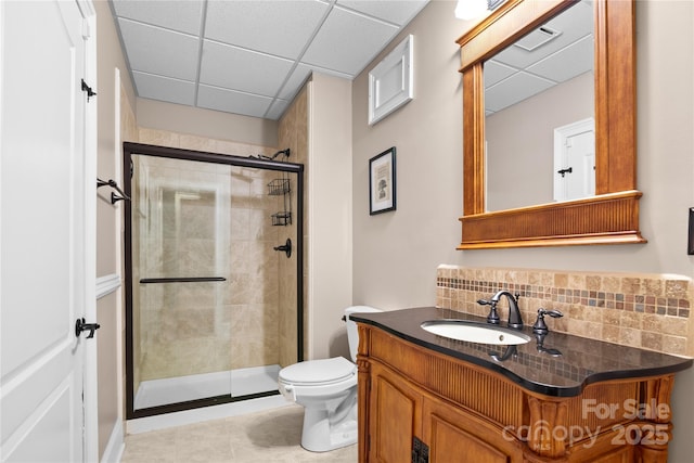 bathroom with tasteful backsplash, vanity, an enclosed shower, and toilet