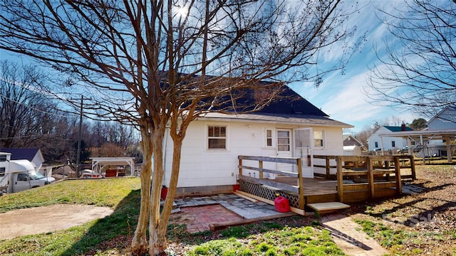 back of property with a lawn and a deck