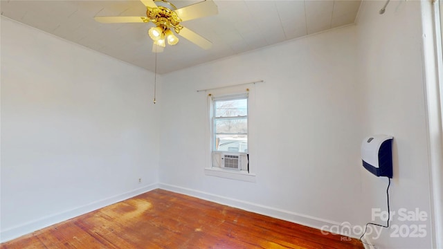 spare room with ceiling fan, baseboards, and wood finished floors