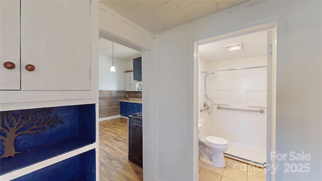 full bath featuring crown molding, walk in shower, toilet, and wood finished floors