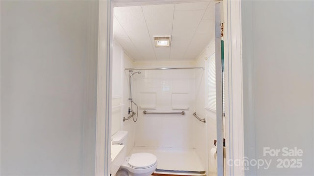 full bath featuring toilet, a stall shower, and visible vents