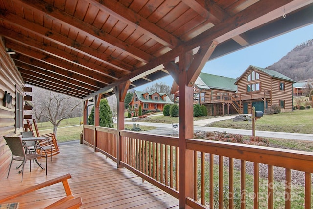 wooden deck with a lawn