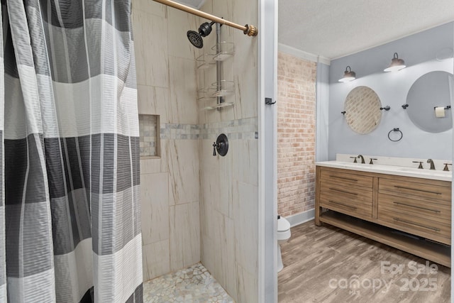 bathroom featuring vanity, wood-type flooring, a textured ceiling, curtained shower, and toilet