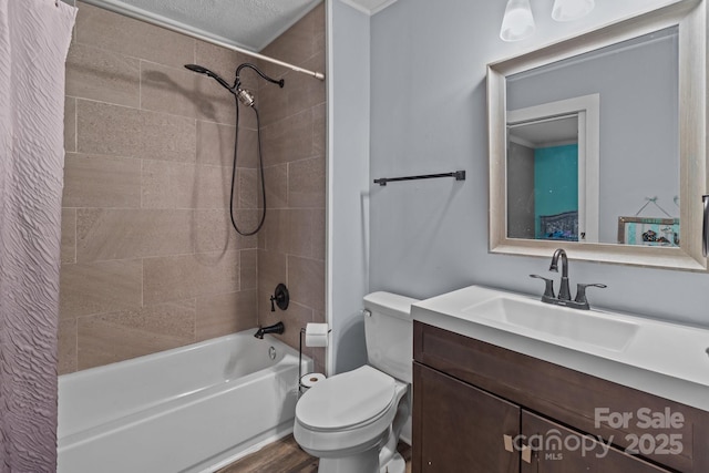 full bathroom with tiled shower / bath, hardwood / wood-style floors, vanity, and toilet