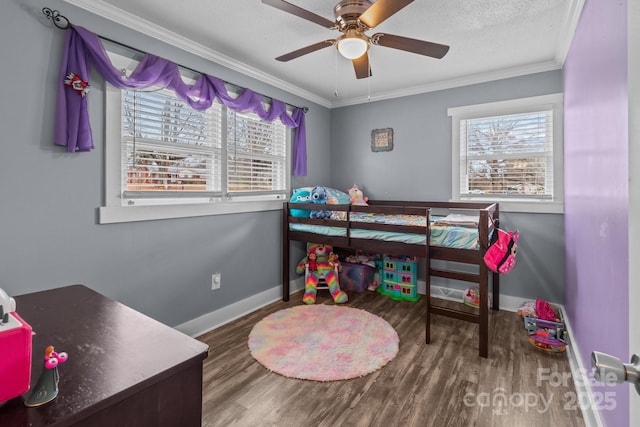 bedroom featuring multiple windows, hardwood / wood-style floors, ornamental molding, and a textured ceiling