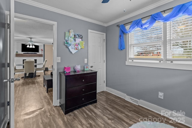 bedroom with multiple windows, crown molding, ceiling fan, and hardwood / wood-style flooring