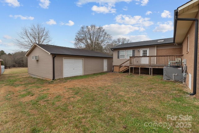 view of yard featuring a garage, an outdoor structure, cooling unit, and a deck