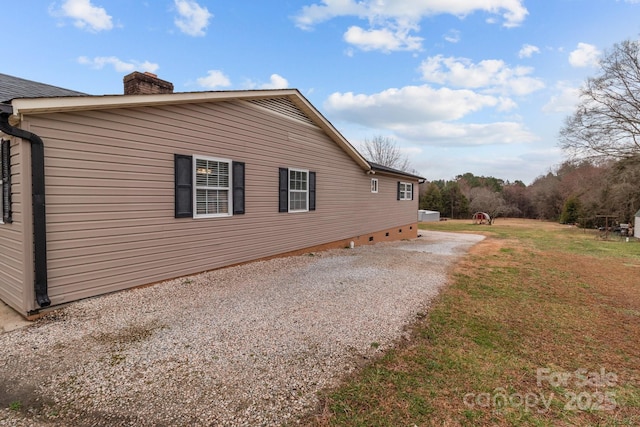 view of side of home featuring a lawn