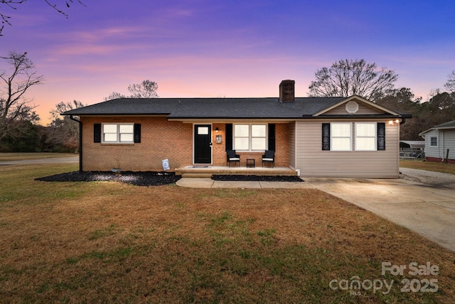 single story home featuring a yard and a porch