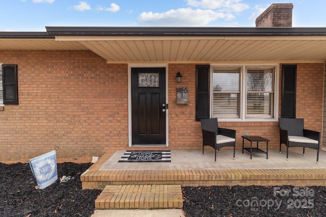 view of exterior entry with a porch