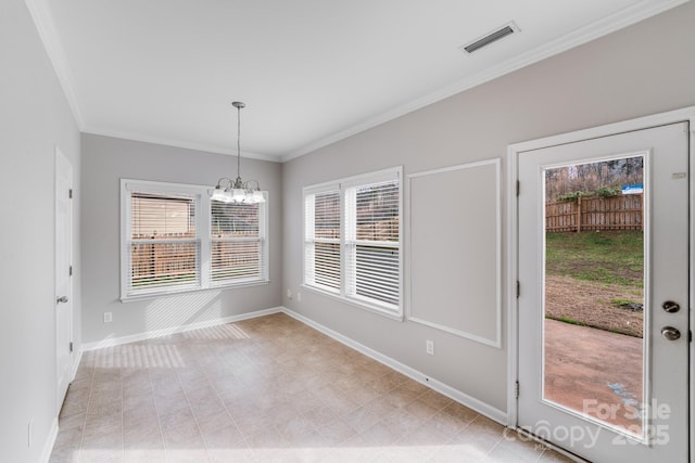 unfurnished dining area featuring crown molding and a notable chandelier