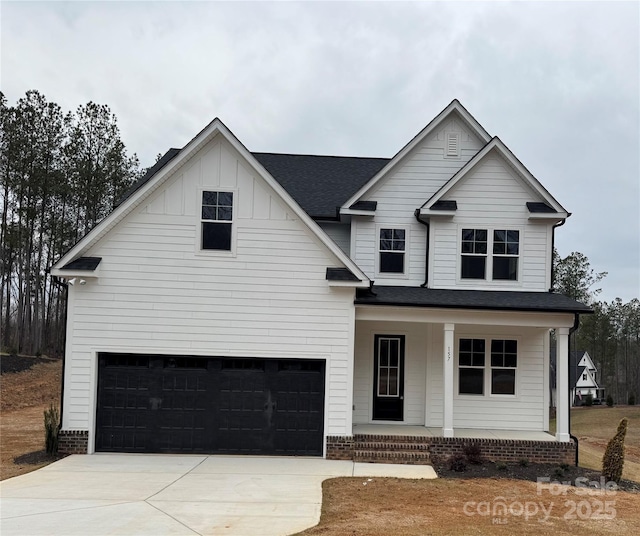 view of front of property with a porch and a garage