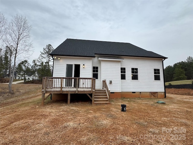 rear view of property with a wooden deck