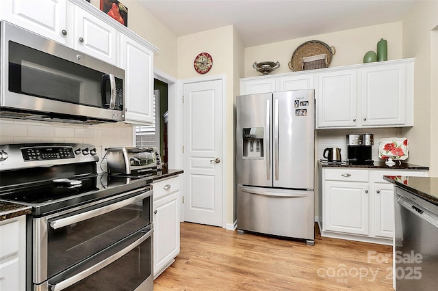 9119 Gander Dr, Charlotte, NC 28277 - kitchen with tasteful backsplash, light hardwood / wood-style floors, white cabinets, and appliances with stainless steel finishes