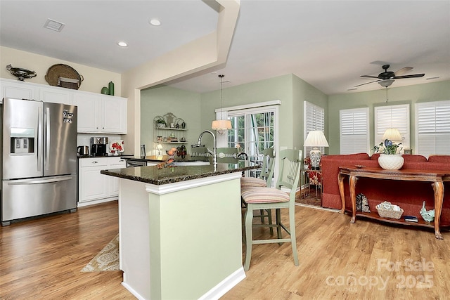 9119 Gander Dr, Charlotte, NC 28277 - kitchen with decorative light fixtures, white cabinetry, sink, a kitchen island with sink, and stainless steel refrigerator with ice dispenser