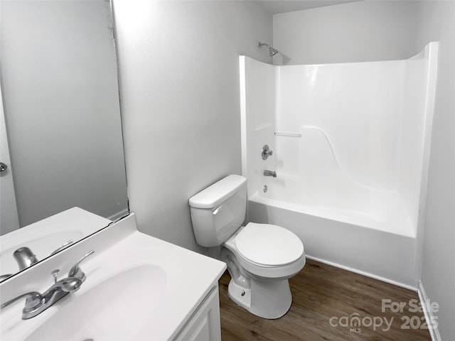 full bathroom featuring vanity, wood-type flooring, toilet, and washtub / shower combination