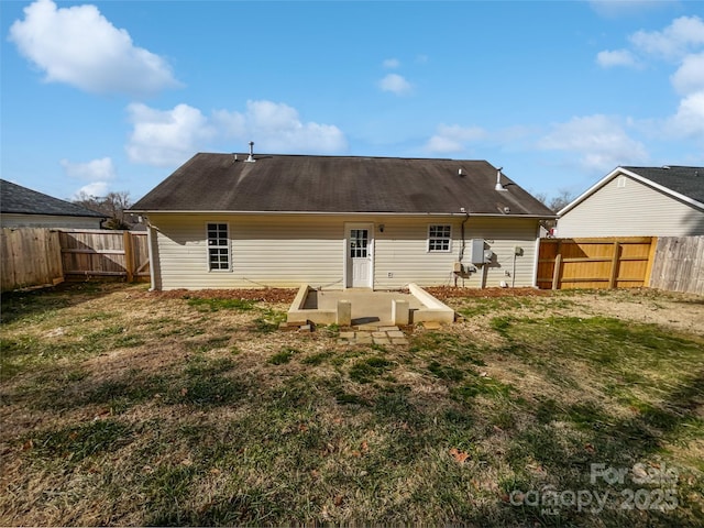 rear view of property with a patio and a lawn