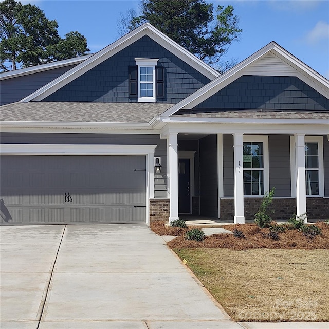 view of front of property featuring a garage and covered porch