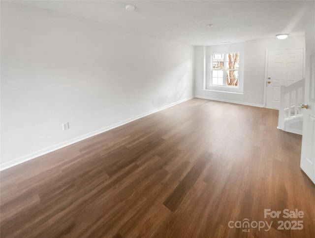 empty room featuring dark hardwood / wood-style flooring