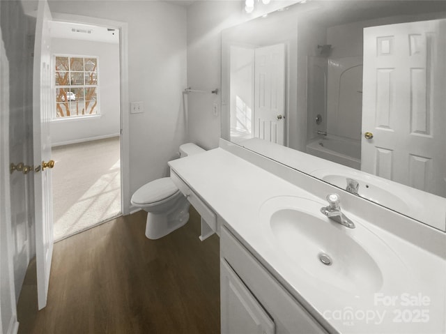 full bathroom featuring shower / bathing tub combination, vanity, wood-type flooring, and toilet