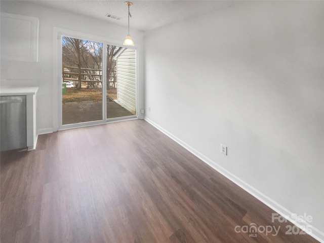 unfurnished dining area featuring dark hardwood / wood-style flooring