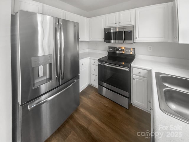 kitchen featuring white cabinetry, dark hardwood / wood-style flooring, and appliances with stainless steel finishes