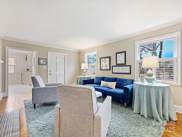 living room featuring a wealth of natural light, ornamental molding, and wood-type flooring