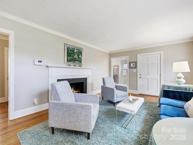 living room featuring hardwood / wood-style flooring and ornamental molding