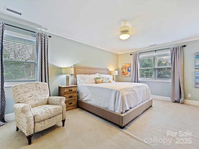 bedroom with crown molding, light colored carpet, and ceiling fan